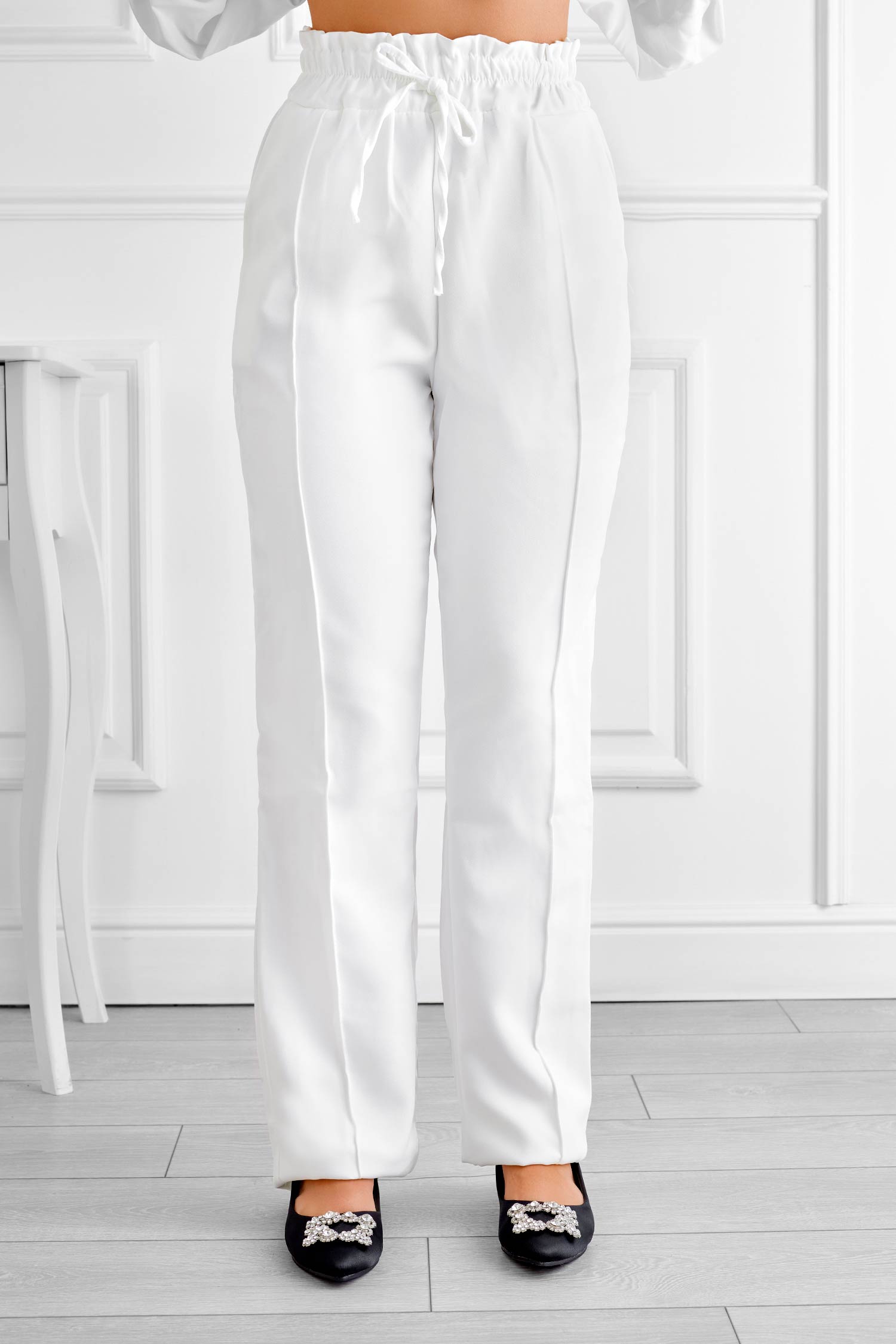 Pantalón blanco con resorte y cordón en la cintura.
